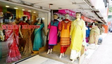 Window-shoppers stroll by storefronts as Eid sale yet to gain pace