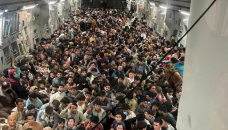 Over 600 fleeing Afghans cram into US military plane