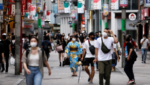 Japan says it will remove more Covid curbs as infections ebb