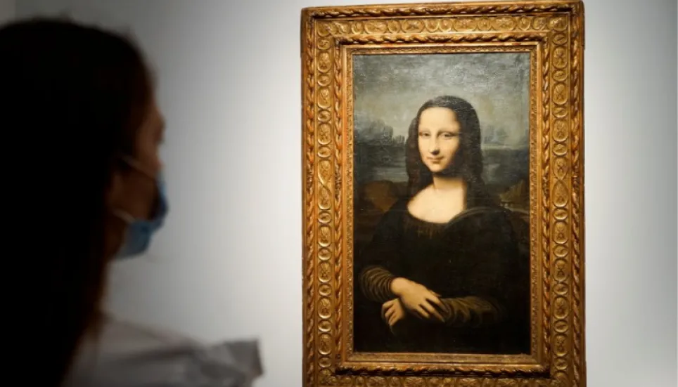 Mona Lisa left unharmed but smeared in cream in climate protest stunt