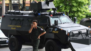 Death toll in Vietnam police station shootings climbs to nine