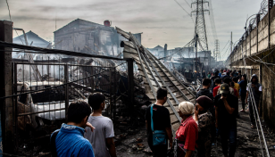 Indonesians search charred homes after fuel depot fire kills 18