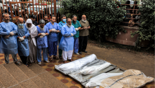 Gaza's embattled main hospital buries patients in mass grave