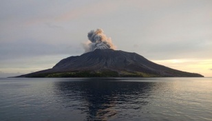 Indonesia lowers volcano alert level, reopens nearby airport