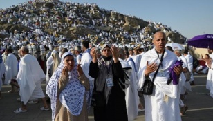 Muslim pilgrims pray on Mount Arafat in Hajj climax