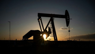 US oil giants report big losses, prepare for longer downturn