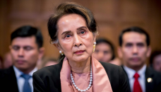 Suu Kyi charged with violating secrets law